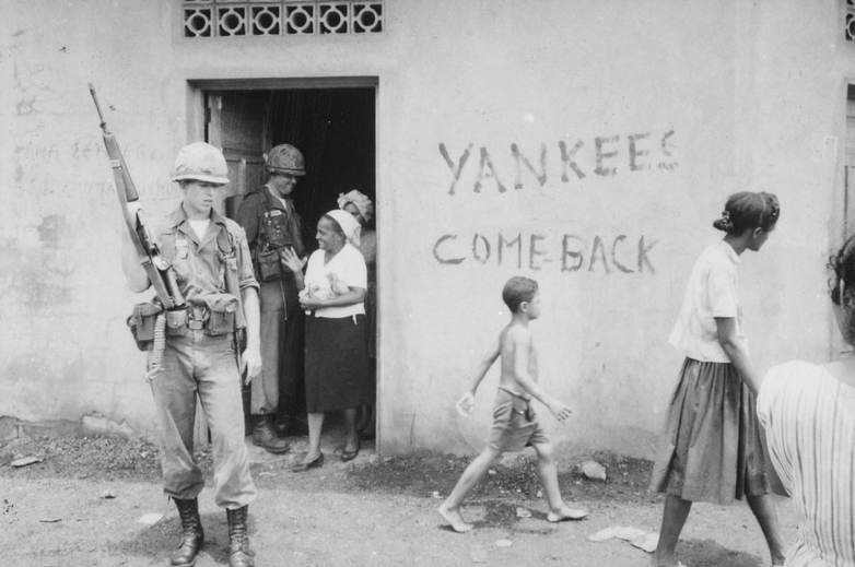 lossy-page1-800px-Food_distribution_in_front_of_-Yankees_come_back-_sign,_Santo_Domingo,_May_9.,_1965_-_NARA_-_541807.tif.jpg